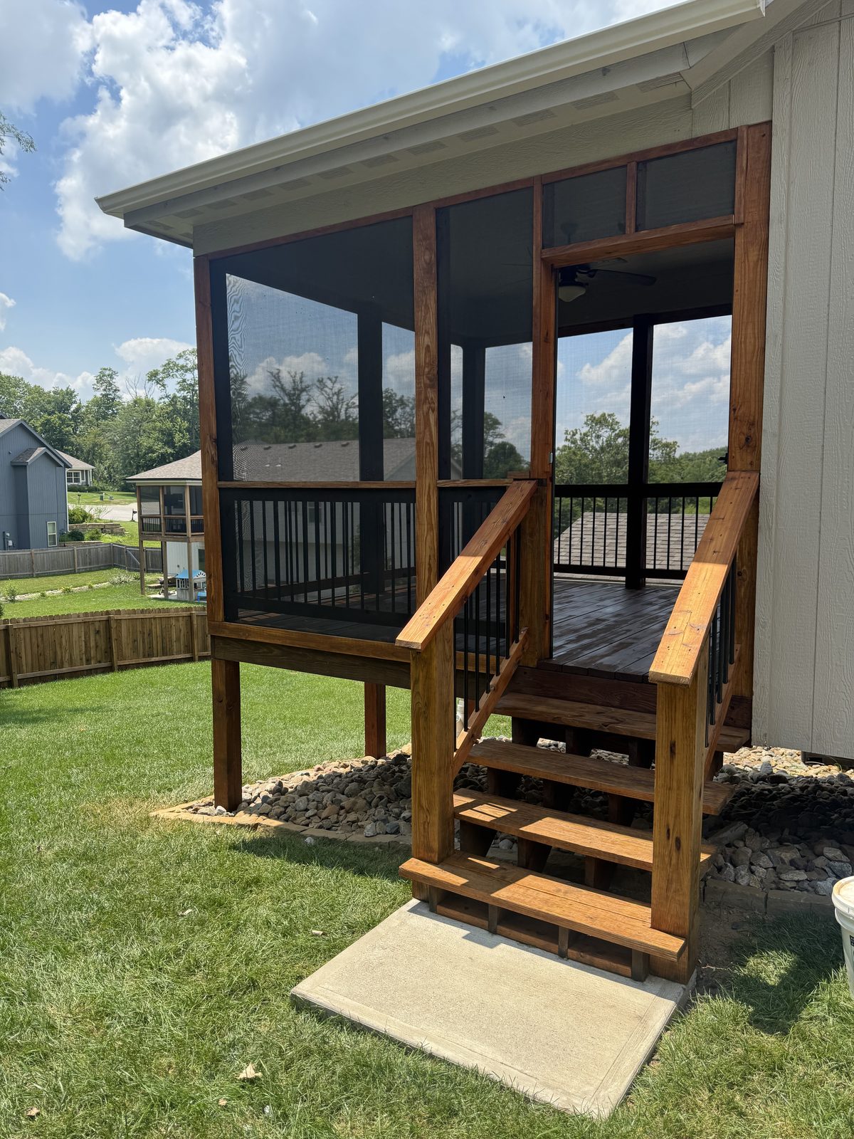 Screened porch and cedar stained deck steps, decks staining in Kansas City by Staining Grain